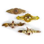 A group of four 9ct gold brooches, set with a variety of stones including rubies, diamond chips, and