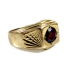 A 9ct gold and garnet gentleman's ring, single round cut stone, 6.0 by 3.0mm, 12.5mm wide, size O/P,