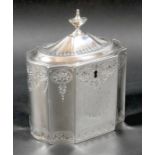 A George III silver tea caddy, of decagon section with caddy top and small urn finial, decorated