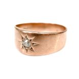 A George V rose gold diamond gypsy ring, set with an old cut circular stone of approximately 3mm /