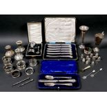 A group of small silver items, including a cased set of six pistol grip butter knives, a cased