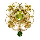 A 9ct gold and green stone openwork brooch, 2.9 by 3.3cm, the lower drop stone of darker hue and