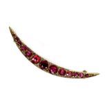 A 9ct rose gold and red stone crescent brooch, the graduated stones interpersed with diamond