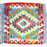 A Chobi Kilim rug, with complex multicolour lozenge pattern to central ground, and stylized borders,