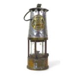 An early 20th century Protector Lamp & Lighting Co. Ltd. safety lamp, GR6, with brass and white