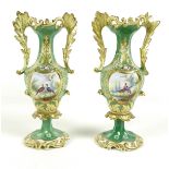 A pair of mid 19th century porcelain twin handled vases, possibly Minton, decorated with reserves