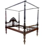 A 19th century mahogany four poster bed, with foliate carved and pierced arched headboard, the