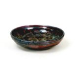 After Michael Cardew (British, 1901-1983): a glazed stoneware bowl, with abstract iron glazed