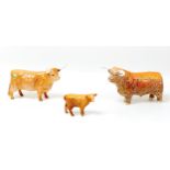 Three Beswick figurines of Highland Cattle, comprising a Bull, 12.5cm high, a cow, 13cm high and a