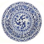 A Chinese Ming style blue and white porcelain dish, late 20th century, with scalloped rim, decorated