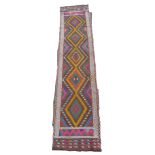 An old Suzni Kilim runner, with five central, caucasian, orange, purple and blue bands of colour,