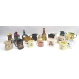 A collection of twenty-one ceramic advertising whisky, gin and rum jugs and decanters. (21)