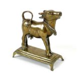 A 19th century Indian brass ornament, modelled as a cow in standing pose with head raised, with