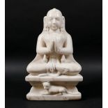 An Asian marble sculpture, modelled as the Jainist deity Mahavira in seated pose,