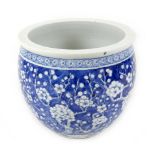 A Chinese porcelain fish bowl, decorated in underglaze blue with prunus blossom against a cracked