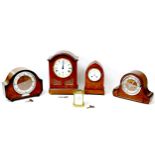 A French Brevette brass carriage clock, 8 by 7 by 12cm high, together with four other clocks,
