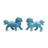 A pair of modern Chinese turquoise glazed figures, modelled as Buddhistic lion dogs. (2)