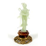 A Chinese carved jade figure, late 20th century, modelled as a lady in standing pose, on a turned