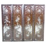 A set of four late 19th century Chinese wooden panels, inlaid with mother of pearl, depicting a main
