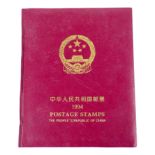 An album of Chinese postage stamps, including commemorative examples.