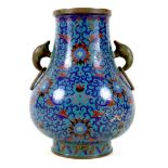A Chinese cloisonné enamel twin handled vase, Qing Dynasty, mid to late 19th century, of Hu form,