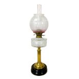 A Victorian paraffin lamp, with clear glass reservoir on a brass column, etched glass globe shade