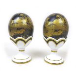 Two Royal Crown Derby Faberge eggs, in 'Black Aves', both in original boxes and egg cups, with