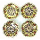 A set of four Royal Crown Derby Imari dishes, 1128, with scalloped edges and richly gilded, 11 by