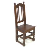 A 17th century oak hall chair