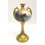 A Royal Worcester twin handled vase by A. Lewis, raised on a trumpet shaped pedestal, painted with