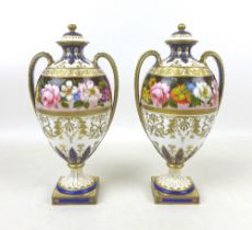 A pair of Royal Crown Derby Albert Gregory lidded vases, of bulbous form, painted with a border of