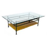 A modern glass topped coffee table, the bronze effect frame with rattan shelf below, 70 by 120 by
