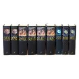 A collection of nine Harry Potter books with first complete adult collection cover art (black),