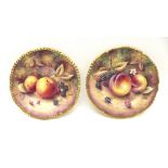 A pair of Royal Worcester fruit study cabinet plates, hand painted with peaches and blackberries and