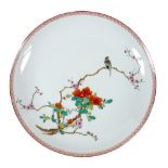A Chinese porcelain dish, mid 20th century, decorated in enamels with a bird on a blossoming branch,