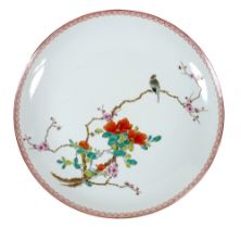 A Chinese porcelain dish, mid 20th century, decorated in enamels with a bird on a blossoming branch,