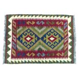 A Maimana Kilim, with two central lozenges upon a green ground, surrounded by red, caucasian, and