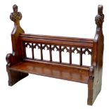 A 19th century oak pew, with carved trefoil ends, pierced back and sides, and low seat, 135 by 46.