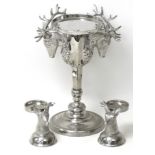 A silver plated three piece garniture set, comprising a centre piece mounted with two stag heads, 23