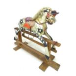 A 1930's Collinson rocking horse, dapple grey on a pine base with original tack, main and tail,