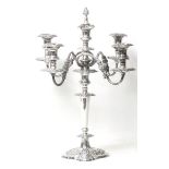 A 20th century Rococo style silver plated four branch candelabra, with scroll decoration, mounted