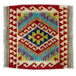 A Chobi Kilim rug, with central dark blue lozenge surrounded by geometric patterned border on