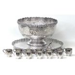 An impressive silver plated punch set, comprising a large punch bowl, decorated with chased