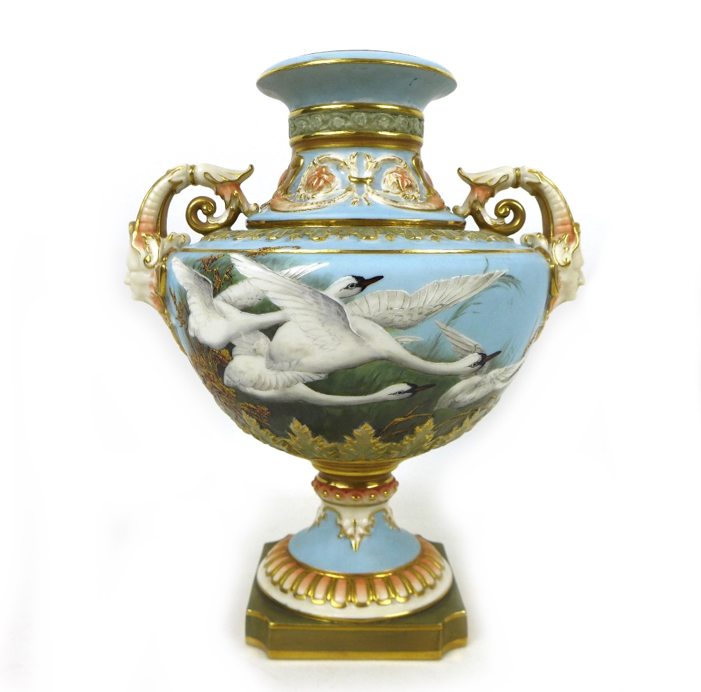 A Royal Worcester vase by Raymond Rea, painted with four swans in flight to a powder blue ground,