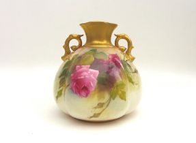 A Royal Worcester twin handled vase, with quarter lobed body, decorated all round with roses, signed