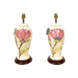 A pair of late 20th century Moorcroft magnolia pattern electric lamp bases, both 37cm high