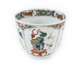 A Chinese porcelain tea bowl, Kangxi mark and period, decorated in famille verte palette with four