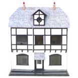 A large early 20th century hand painted wooden dolls house, with assorted furniture and accessories,