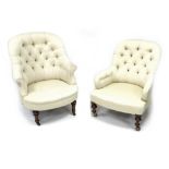 Two Victorian button back tub chairs, both upholstered in cream, turned mahogany legs raised upon