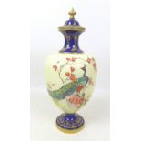 A Royal Worcester vase and cover, painted with a peacock perched on a branch in a blossom tree, on